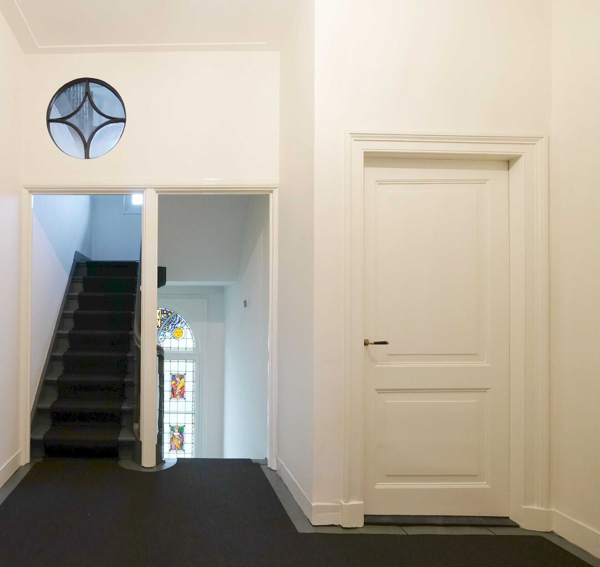 Colour use renovated staircase aligned with the stained glass windows